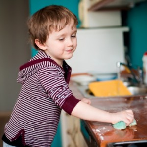 Boy cleaning the kitchen