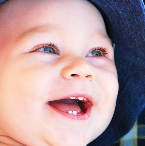 smiling baby with white teeth